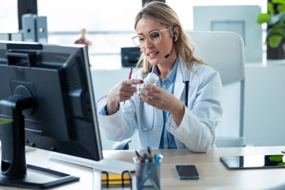 doctor showing patient medicine detail with patient via telehealth